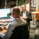 Two men at computer at LW Theatres offices