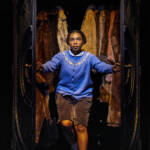 Lucy walks through the wardrobe. The Lion, The Witch and The Wardrobe West End Production photograph.