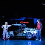 Doc Brown and Marty stand next to the DeLorean Time Machine