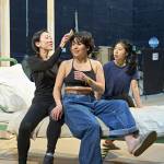 Phyllis Ho fixing Ami Okumura Jones’ hair sitting and on a hospital bed with Victoria Chen behind them.