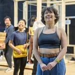 Ami Okumura Jones standing with her hands together and Victoria Chen standing behind her with a yellow bag.